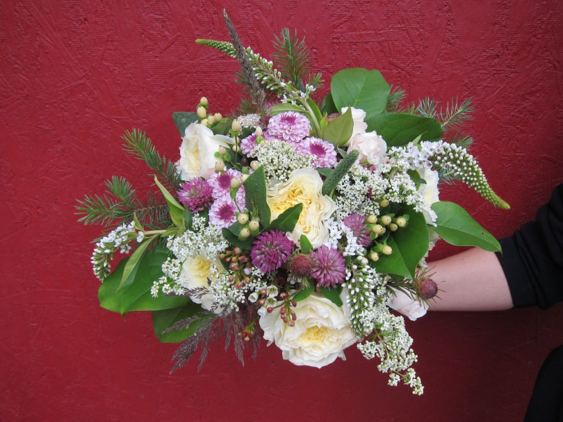 Wild Alaska bridal bouquet with garden roses, lavender button mums, wildflowers, alder, spruce, salal, seeded eucalyptus and a four-leaf clover | designed by Natasha Price of Alaskaknitnat.com