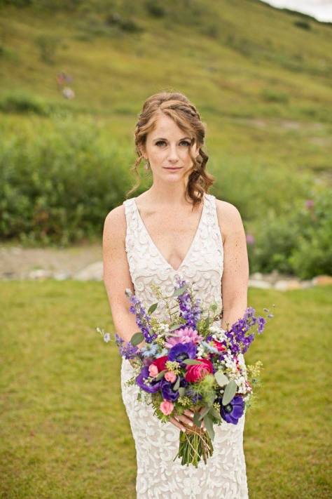 Bridal bouquet made with purple anemones, fuchsia ranunculus, blue nigella, purple larkspur, daisies, baby's breath, pink spray roses and seeded eucalyptus | designed by Natasha Price of Alaskaknitnat.com