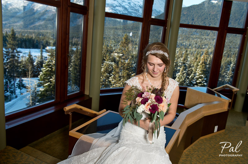 Winter weddings: a bridal bouquet made with peach roses, burgundy chrysanthemums, carnations, alstroemeria, carnations and wax flower. Designed by Natasha Price of Alaskaknitnat.com