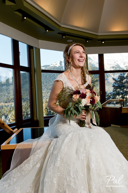 Winter weddings: a bridal bouquet made with peach roses, burgundy chrysanthemums, carnations, alstroemeria, carnations and wax flower. Designed by Natasha Price of Alaskaknitnat.com