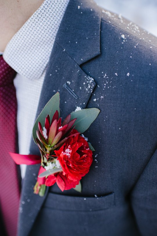 Boutonniere made with ranunculus, leucadendron and eucalyptus | designed by Natasha Price of Alaskaknitnat.com and photo by Sara Olivia Photographer