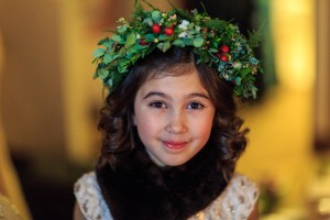 Alaska Winter Wedding: flower crown made with white wax flower, plumosa, eucalyptus, mini myrtle, red hypericum, white statice, and red and white spray roses. It's like a holiday wreath for your head! Designed by Natasha Price of alaskaknitnat.com