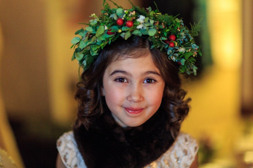 Alaska Winter Wedding: flower crown made with white wax flower, plumosa, eucalyptus, mini myrtle, red hypericum, white statice, and red and white spray roses. It's like a holiday wreath for your head! Designed by Natasha Price of alaskaknitnat.com