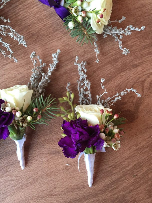 Alaska Winter Wedding | boutonnieres made with white spray roses, statice, sage, waxflower, Sitka spruce, eucalyptus and purple mini carnations. Designed by Natasha Price of Alaskaknitnat.com
