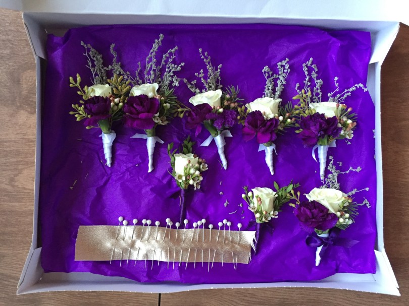 Alaska Winter Wedding | boutonnieres made with white spray roses, statice, sage, waxflower, Sitka spruce, eucalyptus and purple mini carnations. Designed by Natasha Price of Alaskaknitnat.com