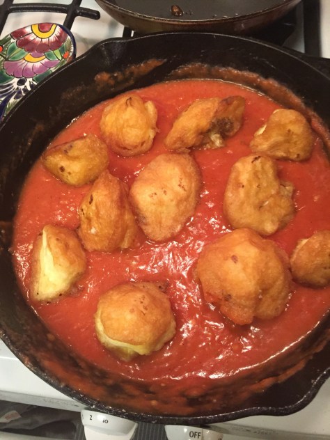 Moña's fried cauliflower | florets coated in a delicate egg batter, pan fried and tossed in a tomato sauce. It's the perfect side dish for any Mexican meal. Recipe from Alaskaknitnat.com