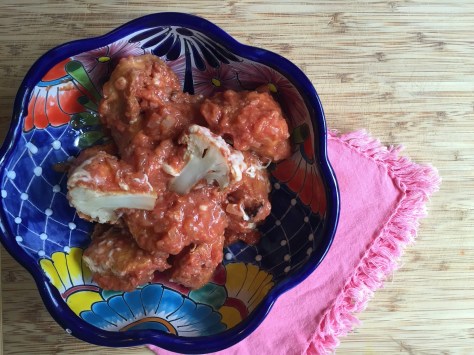Moña's fried cauliflower | florets coated in a delicate egg batter, pan fried and tossed in a tomato sauce. It's the perfect side dish for any Mexican meal. Recipe from Alaskaknitnat.com