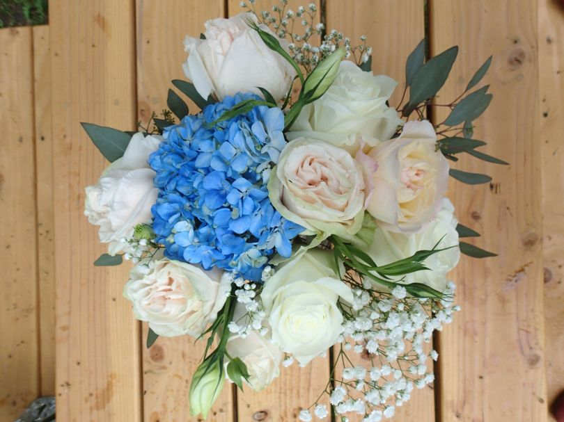 Garden roses, blue hydrangea, lisianthus, baby's breath limonium, seeded eucalyptus and dusty miller | Such a romantic, soft palate for a June wedding. Designed by Natasha Price of Alaskaknitnat.com