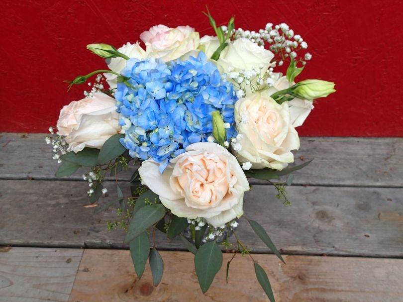 Garden roses, blue hydrangea, lisianthus, baby's breath limonium, seeded eucalyptus and dusty miller | Such a romantic, soft palate for a June wedding. Designed by Natasha Price of Alaskaknitnat.com