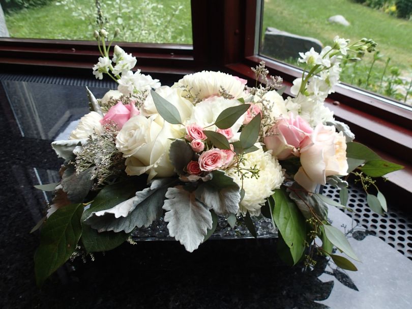 Wedding centerpiece made with garden roses, spray roses, football mums, stock, lisianthus, limonium, dusty miller, salal and seeded eucalyptus | designed by Natasha Price of Alaskaknitnat.com