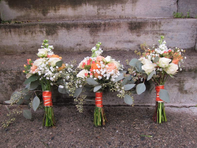 A creamsicle wedding | bridal bouquet made with peach roses, football mums, snapdragon, spray roses, lisianthus, limonium, hypericum, safflower and seeded eucalyptus. Designed by Natasha Price of Alaskaknitnat.com