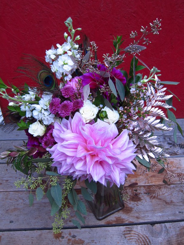 A stunning wedding bouquet with a dinner plate dahlia, gold eucalyptus, ferns, myrtle, waxflower and spray roses | Designed by Natasha Price of alaskaknitnat.com