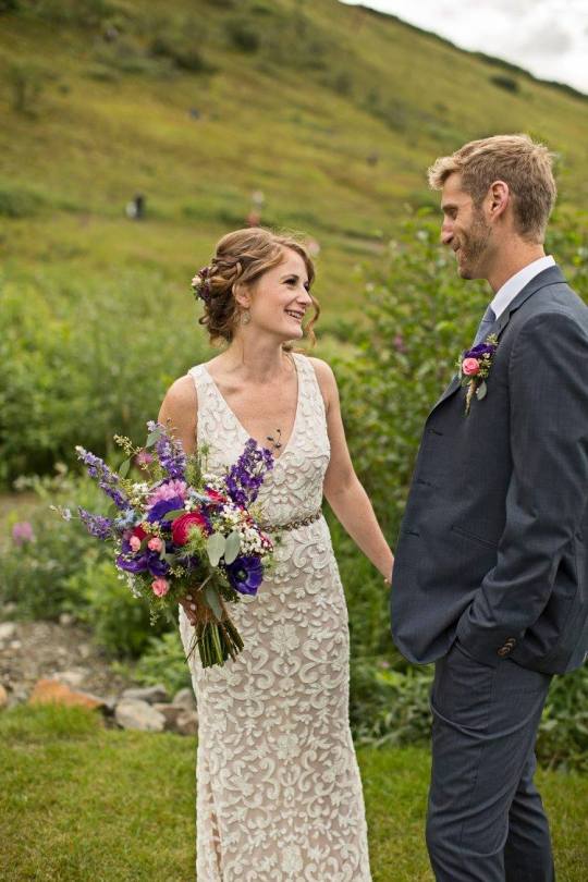Bridal bouquet made with purple anemones, fuchsia ranunculus, blue nigella, purple larkspur, daisies, baby's breath, pink spray roses and seeded eucalyptus | designed by Natasha Price of Alaskaknitnat.com