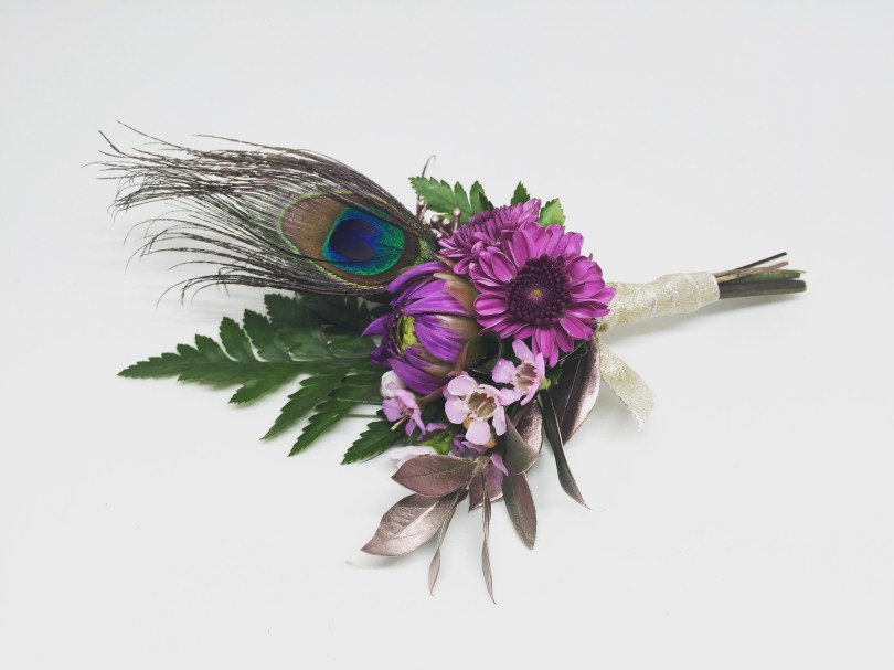 Boutonniere made with button mums, dahlia bud, waxflower, fern and peacock feather | designed by Natasha Price of alaskaknitnat.com