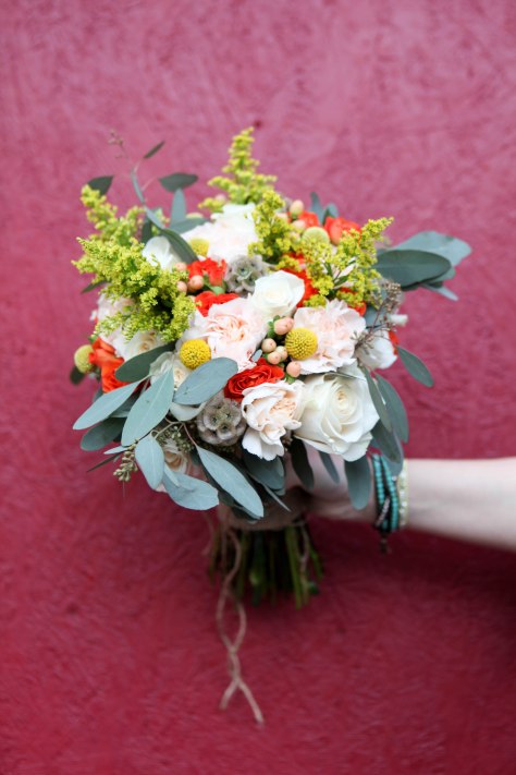 A perfect fall bridal bouquet. Solidago, white roses, orange spray roses, salmon hypericum berry, billy ball, scabiosa pods, peach carnation and seeded eucalyptus wrapped in burlap with jute twine corset | designed by Natasha Price of alaskaknitnat.com