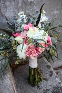Shabby chic bridal bouquet made with eucalyptus, feathers, carnations, football mums, roses, stock and spray roses | designed by Natasha Price of Alaskaknitnat.com