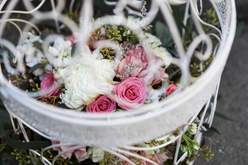 Birdcage flower arrangement for a fairy tale wedding. Made with eucalyptus, carnations, football mums, roses, stock and spray roses | designed by Natasha Price of Alaskaknitnat.com