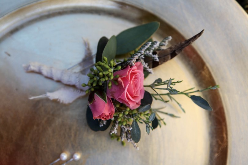 Shabby chic wedding boutonnieres made with limonium, eucalyptus, feathers and spray roses | Designed by Natasha Price of alaskaknitnat.com