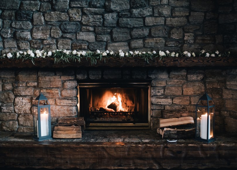 A winter wedding mantle garland made with willow eucalyptus, spray rose and waxflower | designed by Natasha Price and photo by Erica Rose Photography