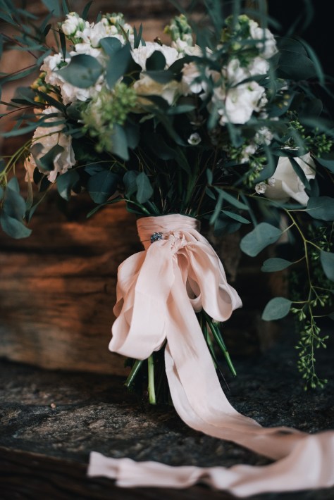 The perfect winter wedding bouquet | roses, stock, waxflower and carnation mixed with eucalytpus. Flowers by Natasha Price and photo by Erica Rose Photography
